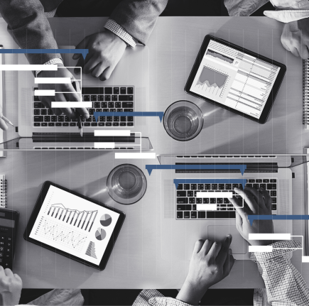 a black and white photo of people using ERP software to manage a business